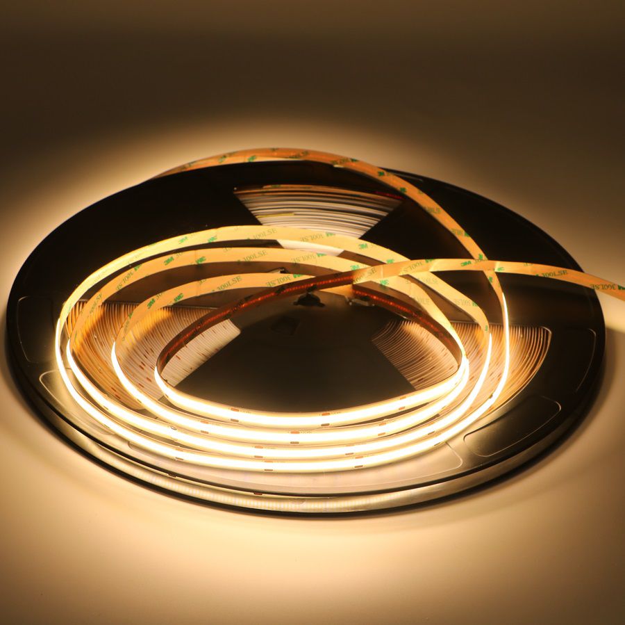 Ultra-long COB LED strip emitting warm white light around a reel
